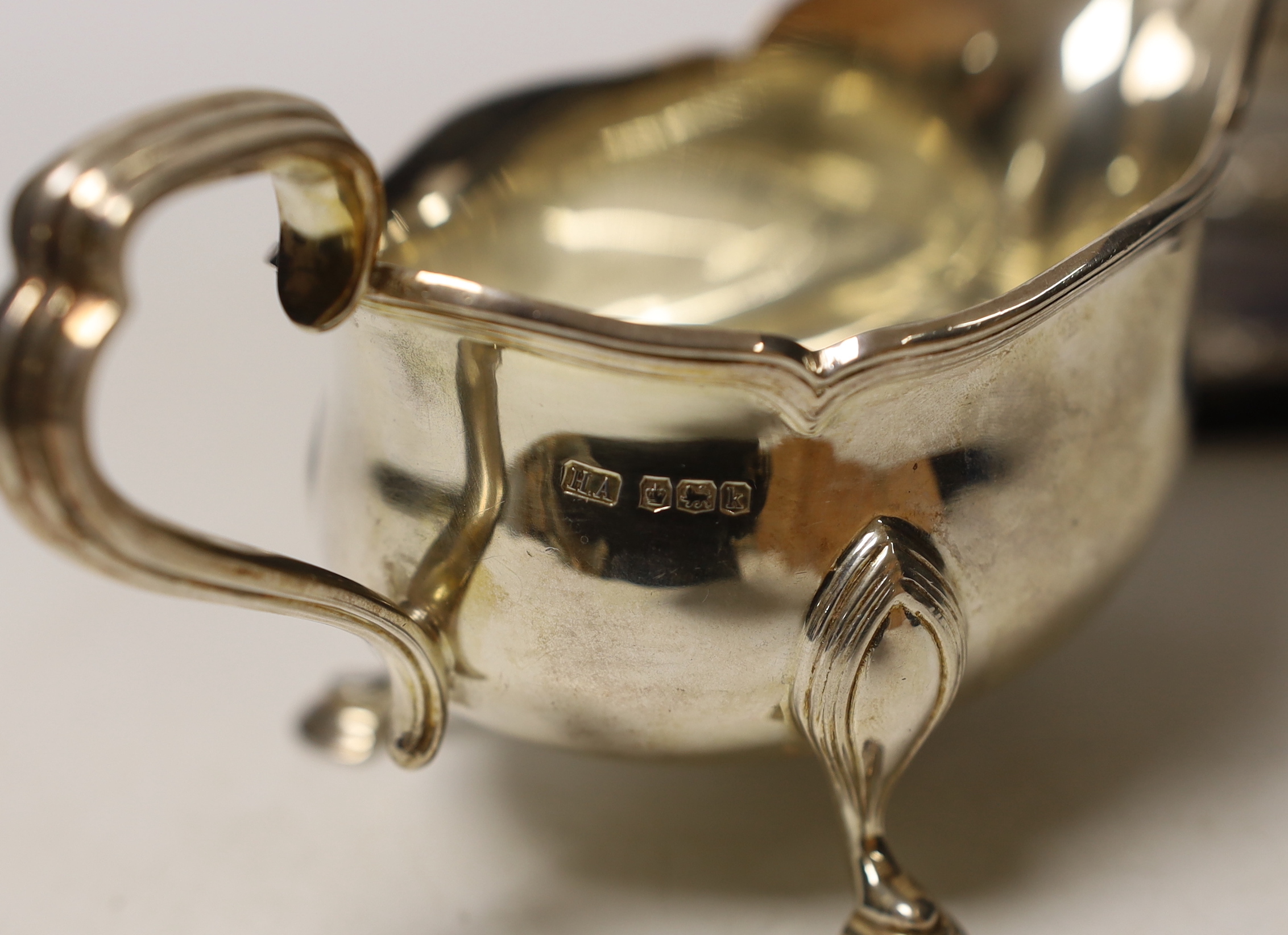 A pair of George V silver sauce boats, Atkin Brothers, Sheffield, 1927, 15.1oz, together with a modern silver mounted double photograph frame.